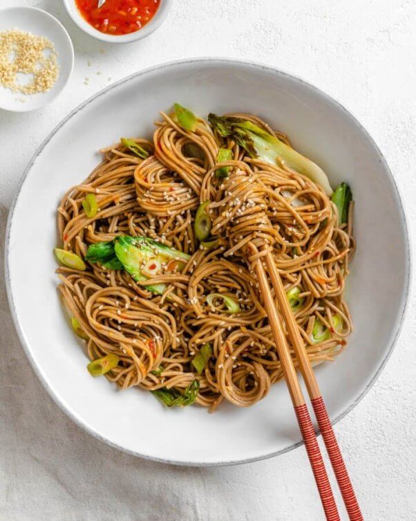 vegan sesame soba noodles in a bowl with chopsticks