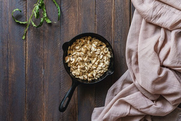 roasted pumpkin seeds in a small cast iron pan