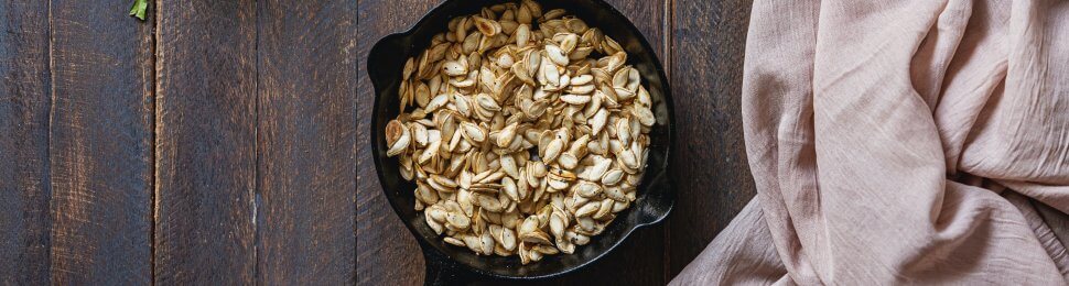 roasted pumpkin seeds in a small cast iron pan