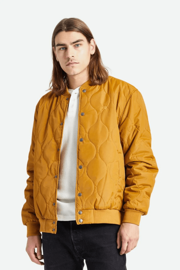 male model wearing a yellow quilted vegan bomber jacket