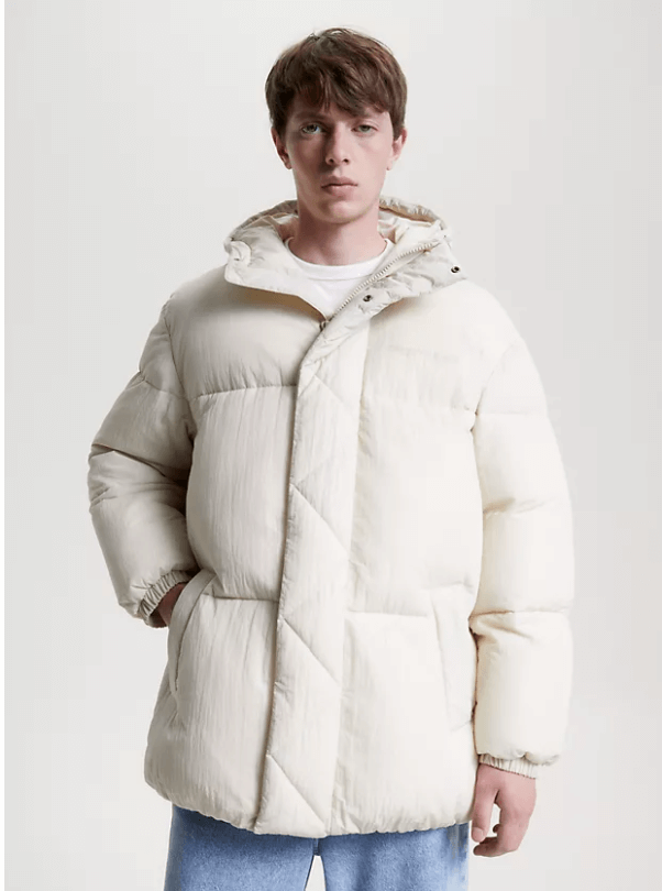 male model wearing a white vegan puffer jacket from Tommy Hilfiger
