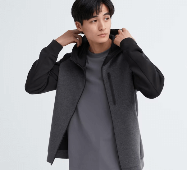 male model wearing a sporty charcoal colored jacket from UNIQLO