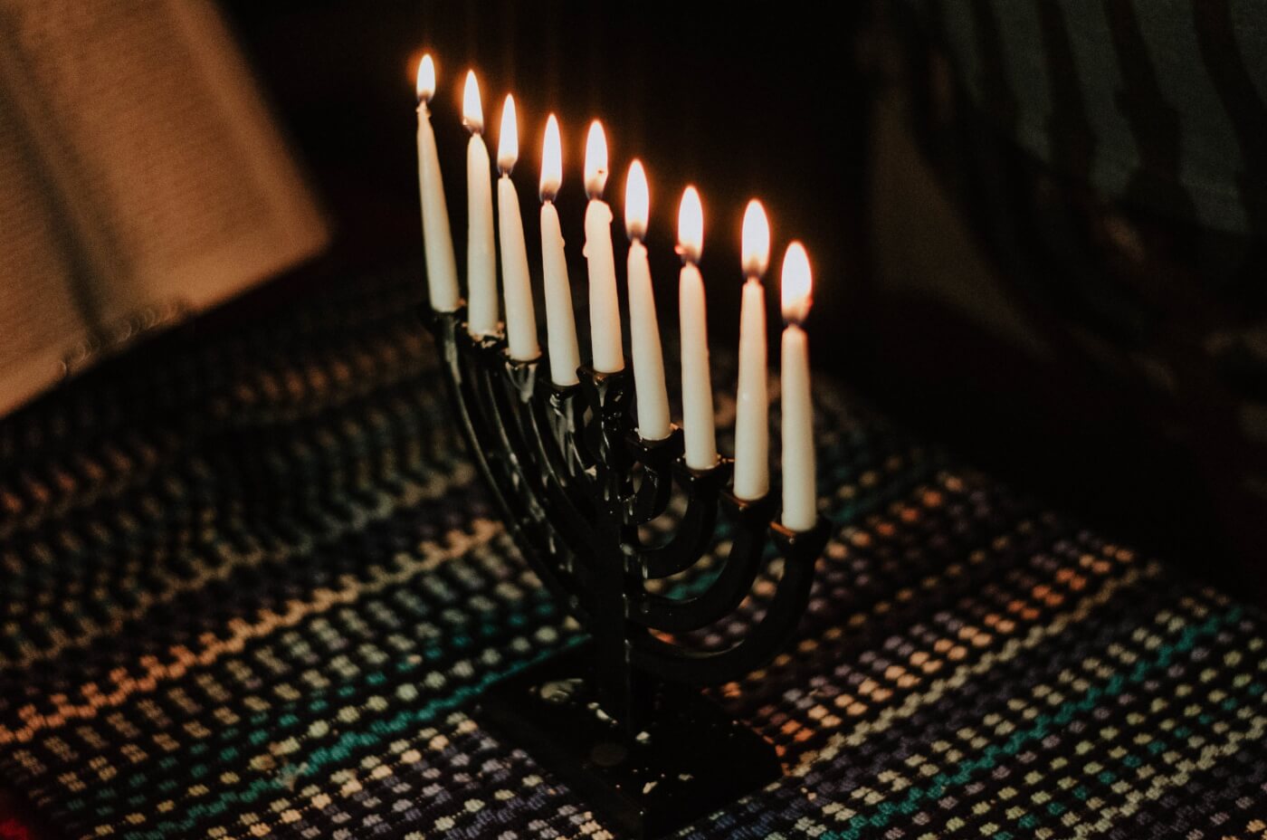 black and white menorah with lit candles