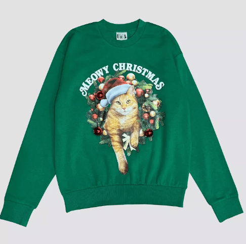 green sweatshirt with an image of a cat in a santa hat, surrounded by ornaments, with text reading "meowy christmas"