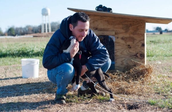 PETA Volunteer Delivering Doghouse to Chained Dog