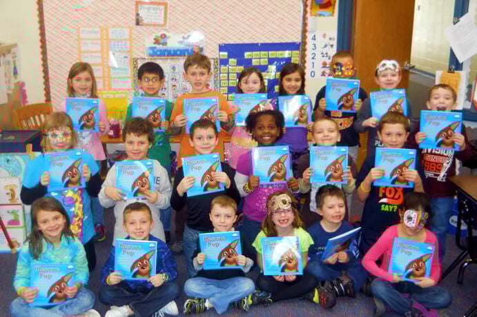 students with books in classroom