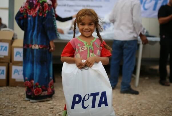 Little girl with PETA bag at refugee camp in Iraq