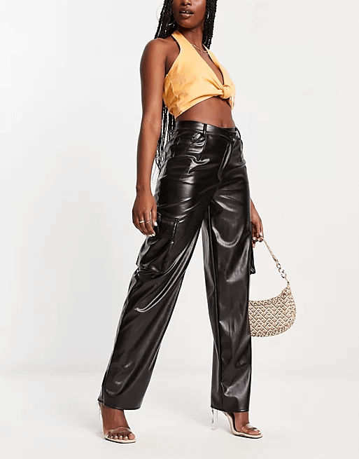 model wearing black vegan leather pants and a crop top