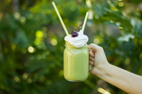 Vegan St. Patrick's Day Mint Shake with Coconut Whipped Cream and Cherry