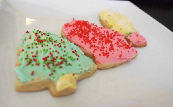 frosted vegan sugar cookies in various cut out shapes on a white plate