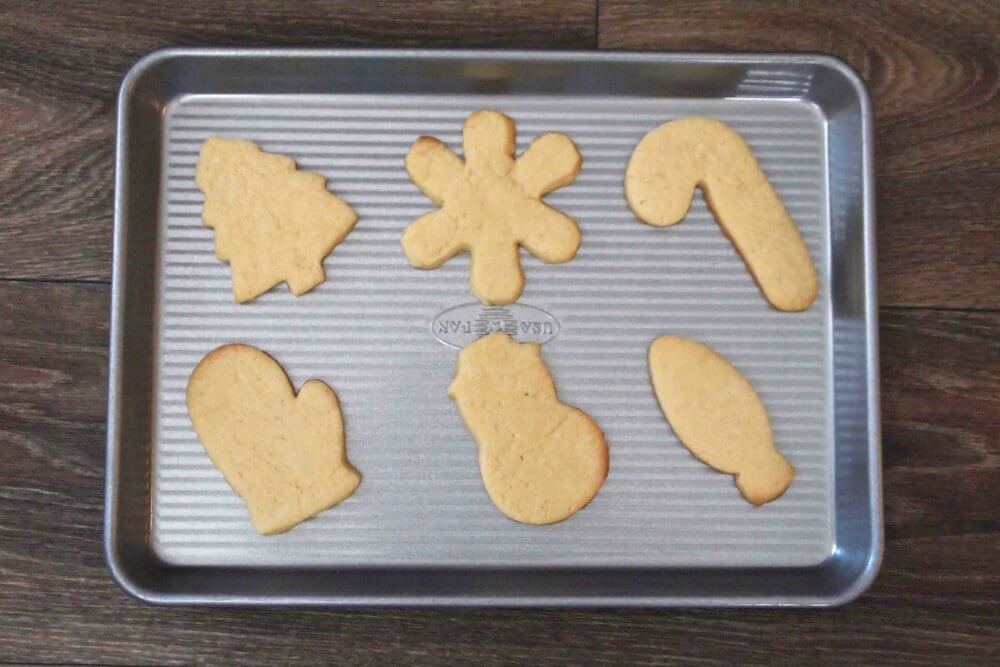 unfrosted sugar cookies in various cut out shapes on a baking sheet