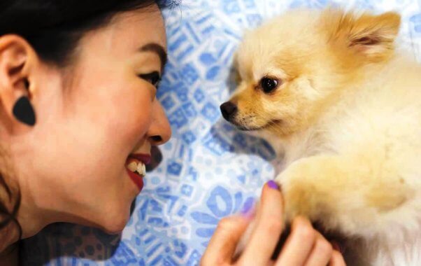 Smiling woman with small dog