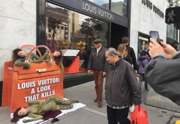 Body-painted "reptiles" outside Louis Vuitton San Francisco store