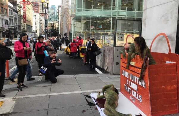 Body-painted "reptiles" outside Louis Vuitton San Francisco store