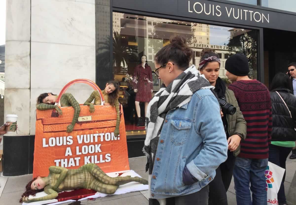 Body-painted "reptiles" outside Louis Vuitton San Francisco store