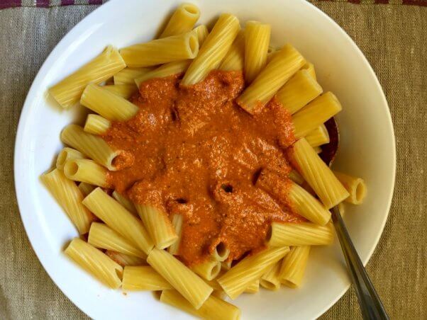 Bowl of rigatoni pasta with vegan cashew cream marina sauce