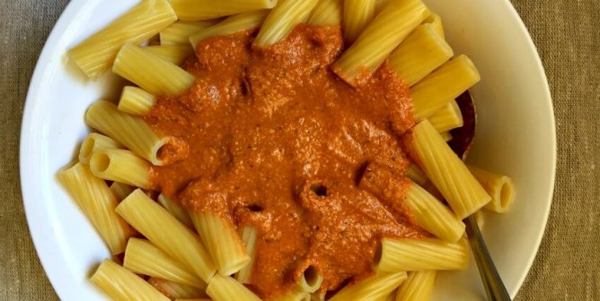 Bowl of rigatoni pasta with vegan cashew cream marina sauce