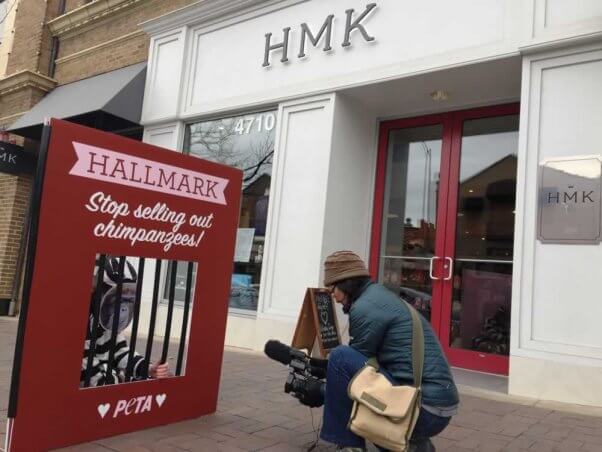 Man photographing PETA demo outside Hallmark headquarters