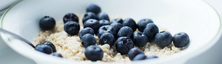 White bowl of oatmeal with blueberries