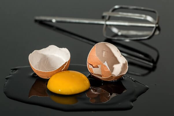 Broken or Cracked Egg with Yolk Spilling