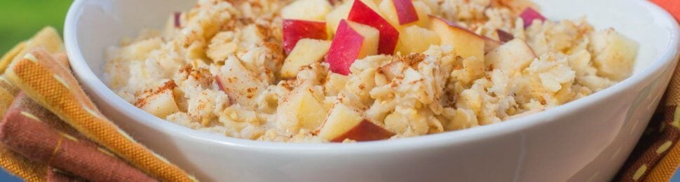 bowl of vegan oatmeal with cinnamon and apples