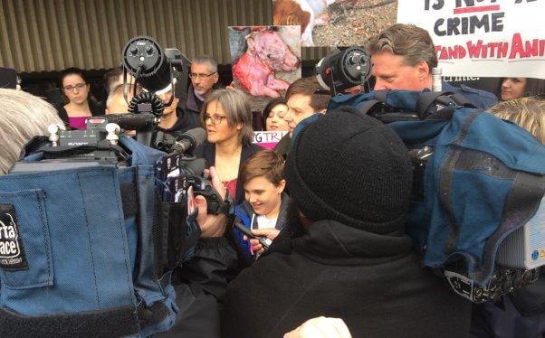 Anita speaking to a throng of reporters