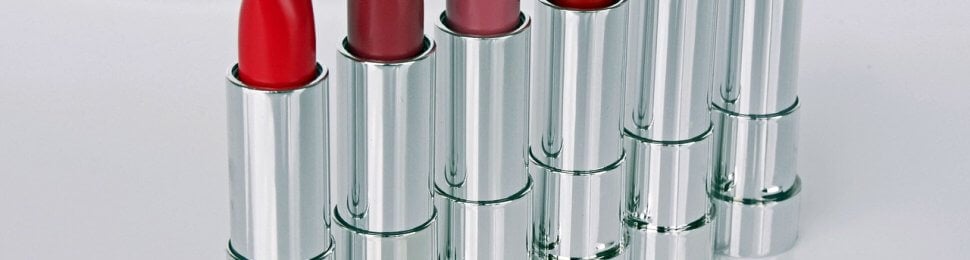 Tubes of red lipstick all in a row.
