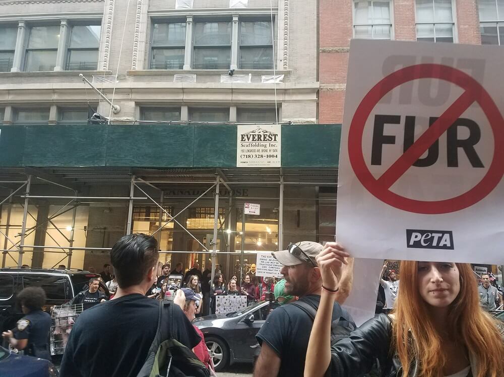 NEW YORK, NY - FEBRUARY 12: Animal Rights Protesters holding signs protest  in front of the Louis Vuitton store in SOHO during an Anti-Fur March on  February 12, 2022in New York City.