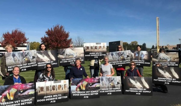 Protesters holding signs outside Patterson Vet Supply 