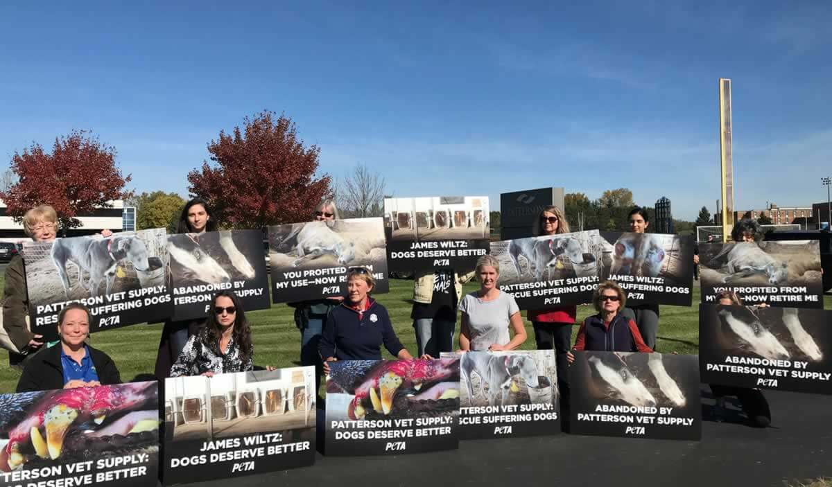 Protesters holding signs outside Patterson Vet Supply