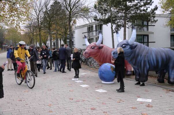 A throng of bicyclists in front of PETA's climate change demo