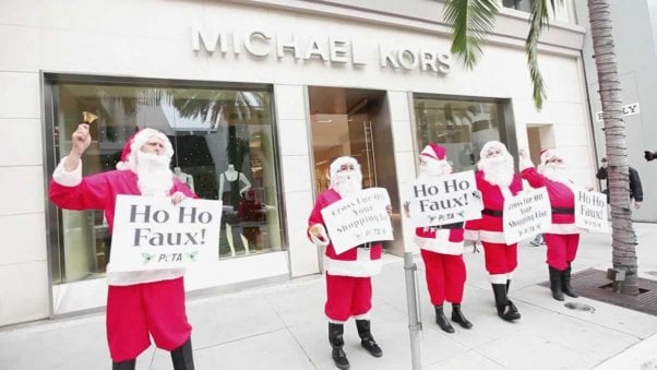 Five protesters in Santa costumes demonstrate against fur at Michael Kors store
