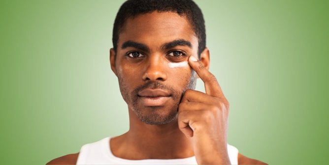 man applying skincare to his face
