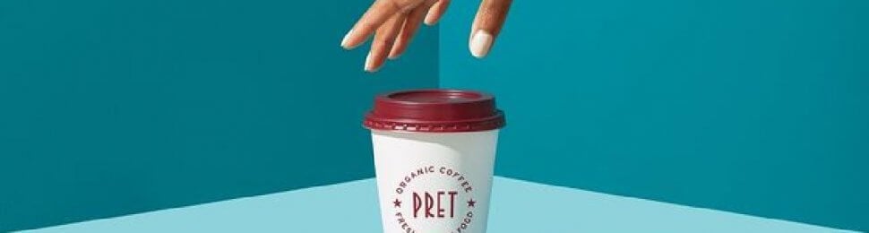 hand reaching for a pret a manger coffee cup