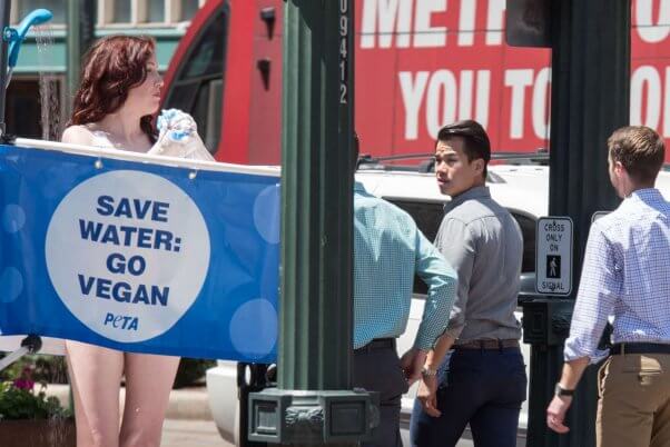 a man's wandering eye falls upon a peta activist during a shower demo