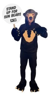Halloween costume of Angela the standing sun bear holding a sign that says "Stand Up for Sun Bears", as one of PETA's latest animal rights costumes