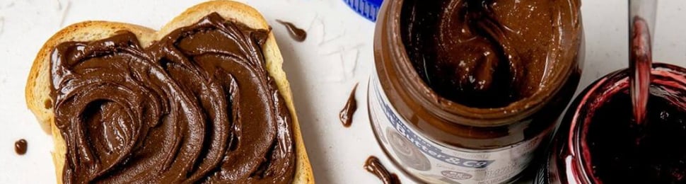a lifestyle shot of vegan nutella spread onto two pieces of toast