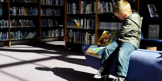 child reading in a library