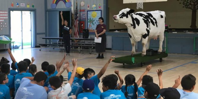 Kids in audience asking questions about Carly the cow