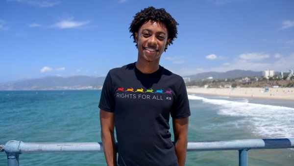 model wearing a black peta tishirt at the beach