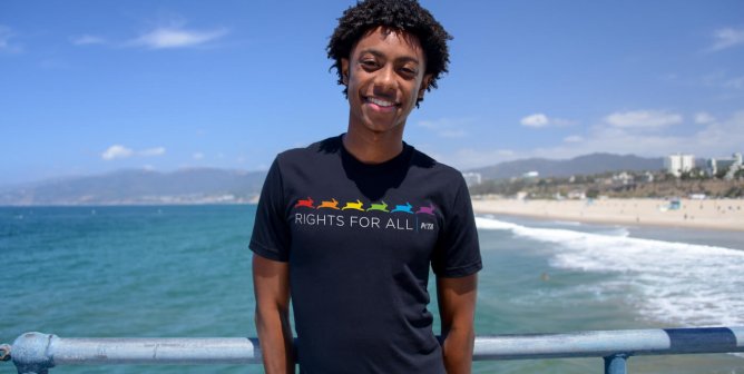 model wearing a black peta tishirt at the beach