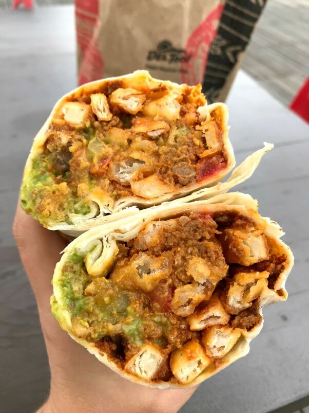 vegan burrito from del taco cut in half