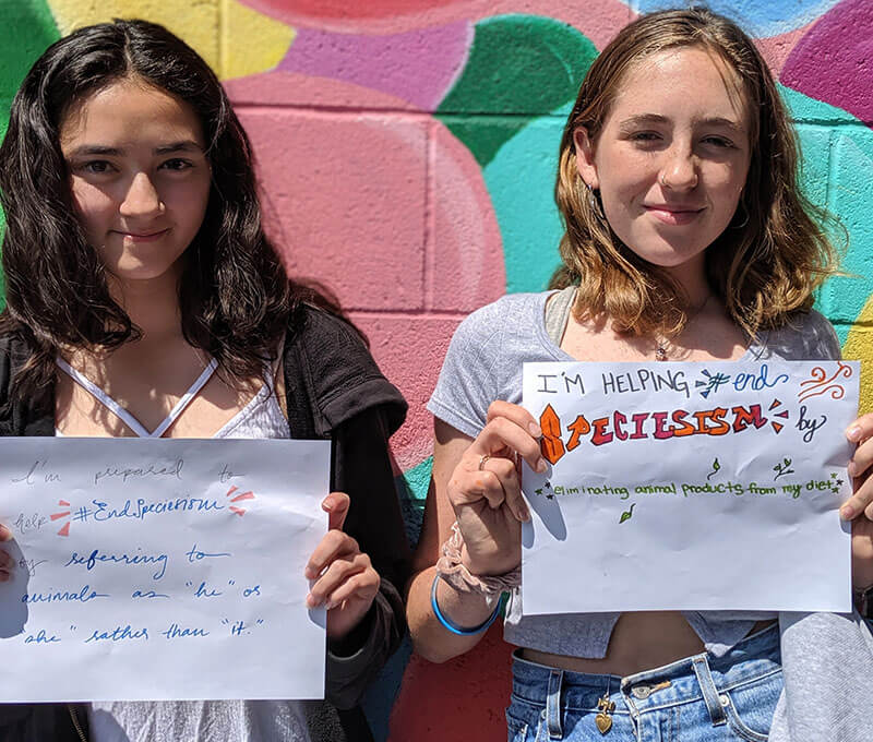 interns holding signs to help end speciesism