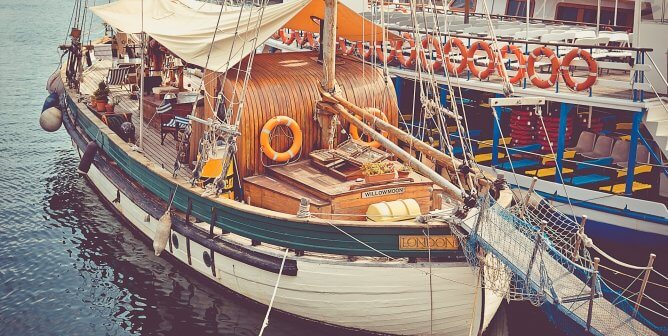 fishing boat docked at the harbor with a white hull
