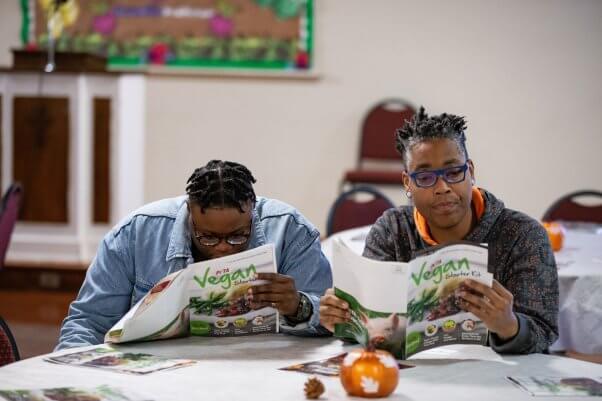 People Reading Vegan Starter Kits at Vegan Thanksgiving Event