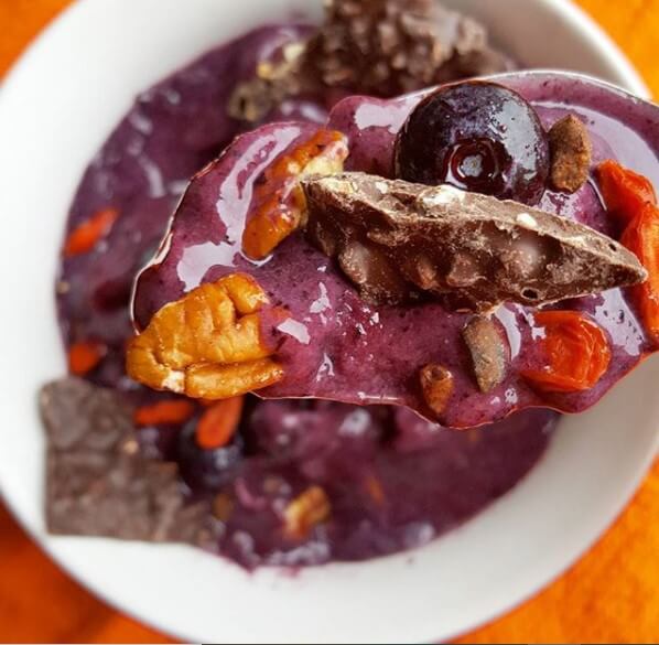 blueberry smoothie bowl with pecans and chocolate