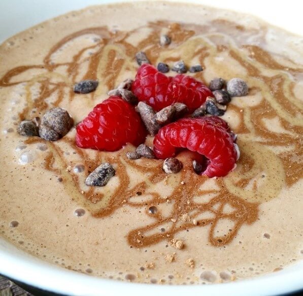chocolate smoothie bowl with chocolate drizzle and raspberries