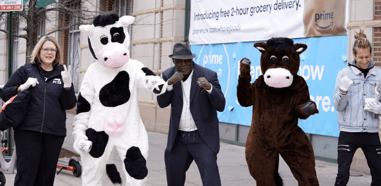 'Cows' and PETA volunteers dance with Baltimore resident