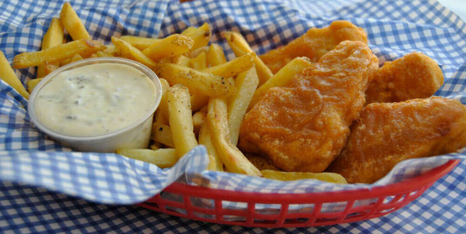 Gardein vegan fish fillets, fries, and vegan tartar sauce in a basket