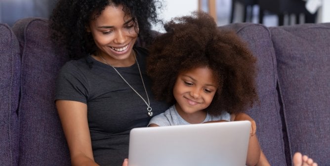 Mother and daughter sharing a computer